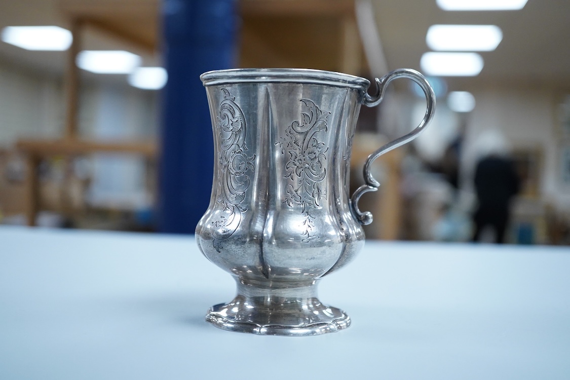 A Victorian engraved silver christening mug, on a pedestal foot, by Daniel & Charles Houle, London, 1848, 97mm, 4.4oz.